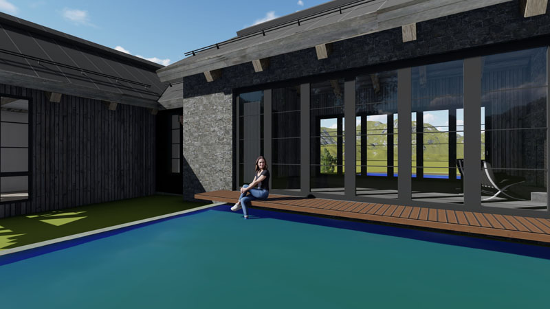 A woman sits on the edge of a modern outdoor pool, her feet in the water. The pool is adjacent to a contemporary house with striking architecture, featuring large glass windows and dark stone walls. The sky is clear, and there are green hills visible in the background.